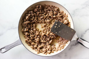 Ground pork sausage in a skillet to make country gravy.
