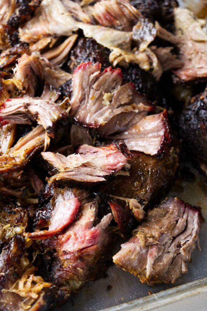 Shredded pork butt showing a smoke ring from the pellet grill.