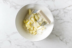 Using a pastry blender to cut the butter into the flour.