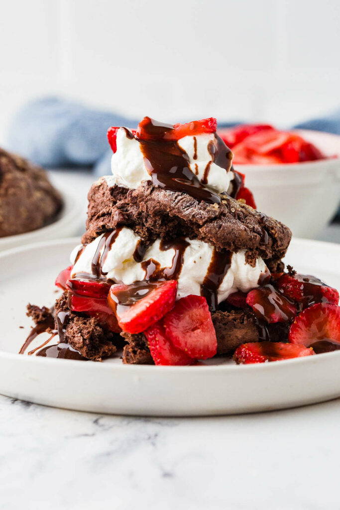 A sourdough chocolate strawberry shortcake and a bowl of strawberries.