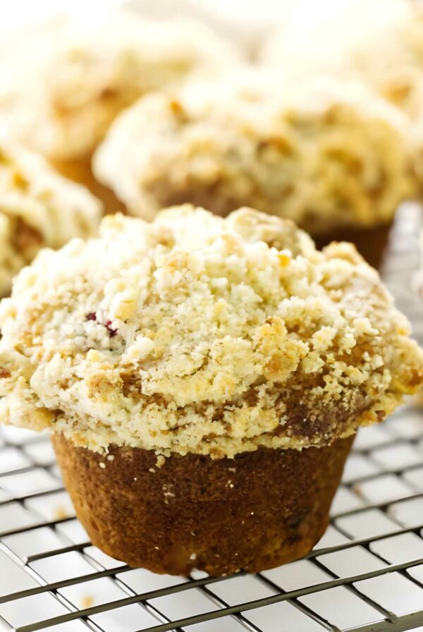 Close-up of a crumb-topped muffin on a cooling rack.