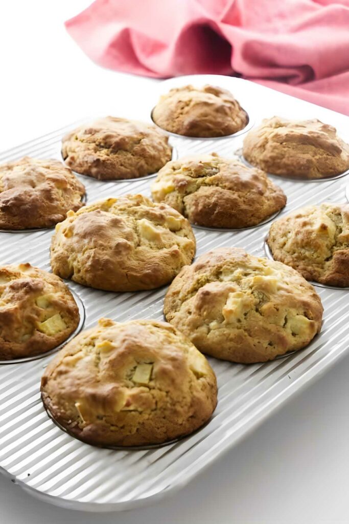 Warm apple muffins in a muffin pan.