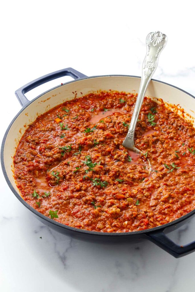 A skillet of slow simmered meat based pasta sauce.