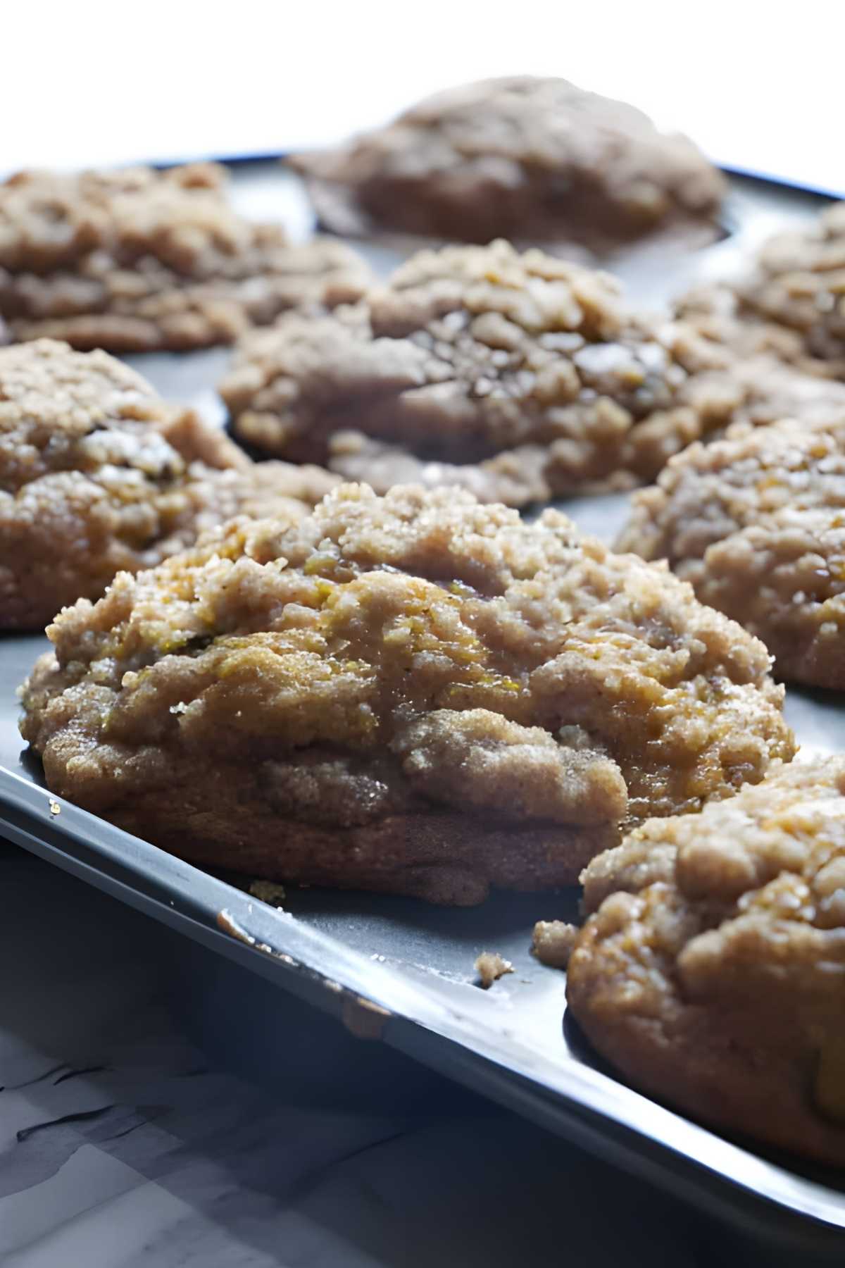 Close-up of crumb-topped muffins on a baking tray.