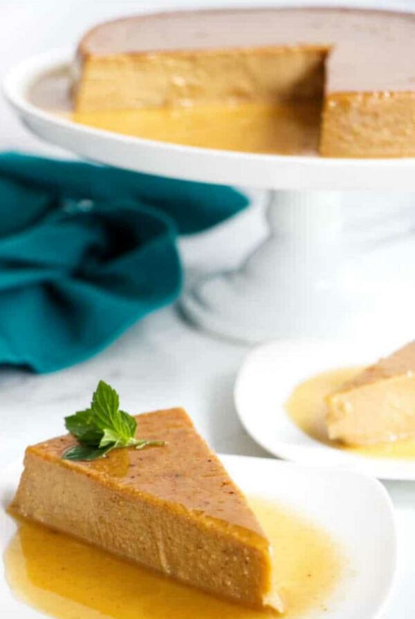 A caramel pumpkin flan slice with mint garnish.