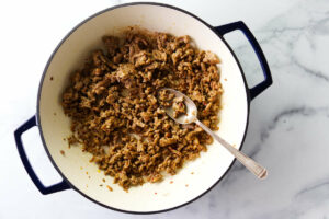Ground sausage browned in a skillet.