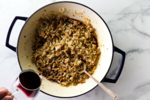 Deglazing the pan with red wine.