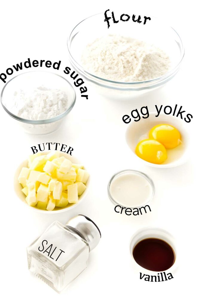 Labeled baking ingredients: flour, powdered sugar, butter, egg yolks, cream, salt, vanilla.