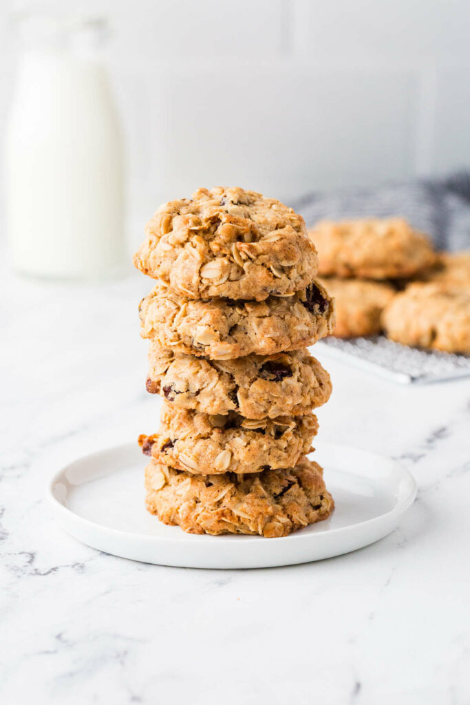 A stack of five sourdough oatmeal raisin cookies on a plate.