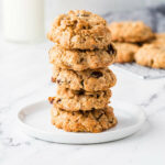 A stack of sourdough discard oatmeal cookies on a white plate.