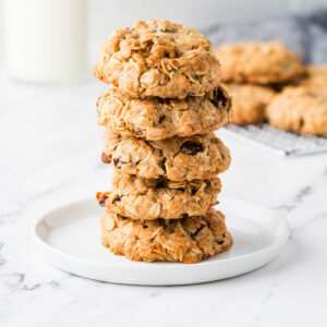 A stack of sourdough discard oatmeal cookies on a white plate.