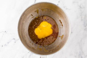 Adding egg yolks to the discard cookie dough.