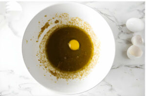 Blending eggs into the batter.