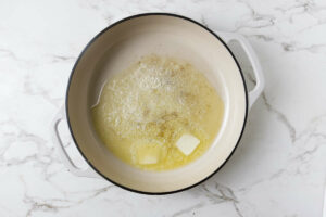 Melting butter in a large skillet.