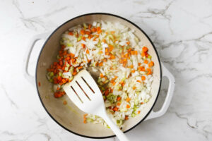 Sautéing vegetables in a large skillet.
