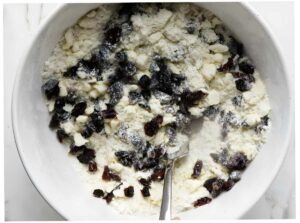 Adding chocolate chips to sourdough scone recipe.