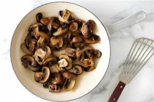 Sauteeing mushrooms in a skillet.