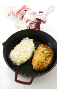 Frying panko chicken cutlets in a skillet.