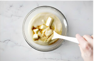 Stirring butter and vanilla paste into the pastry cream.