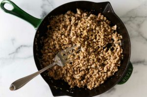 Ground pork cooked in a skillet.