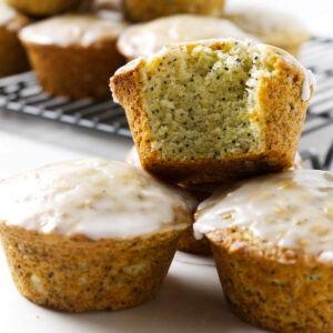 Three lemon poppyseed muffins stacked on each other.