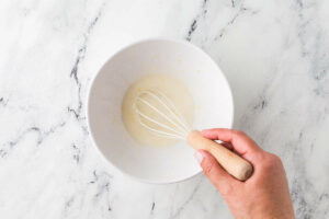 Whisking the lemon glaze for the tops of the muffins.