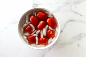Shocking blanched tomatoes in ice water.