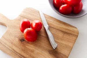 Cutting a cross hatch in the skin of tomatoes.
