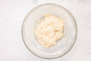 Mixing dough in a bowl.