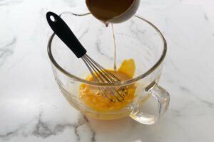 Tempering egg yolks for the a caramel custard recipe.