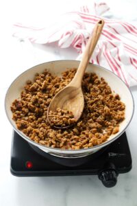 Cooking ground sausage in a skillet.