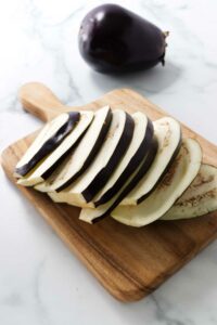 An eggplant cut into thin slices.