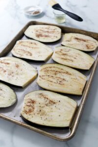 Eggplant slices on a baking sheet.