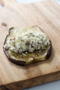 Adding a filling to a slice of eggplant.