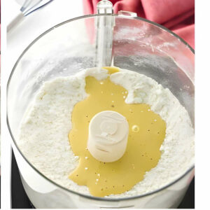 Adding the egg to a shortbread pastry dough.