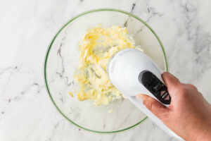 Creaming butter and sugar in a bowl.