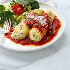 Two manicotti filled with a three cheese blend.