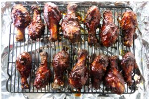 Chicken legs cooking on a grill.