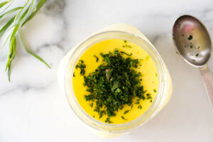 Adding tarragon to Béarnaise Sauce in a jar.