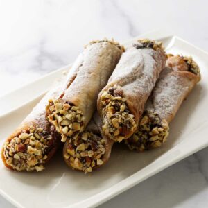 Several chocolate hazelnut filled cannoli on a plate.
