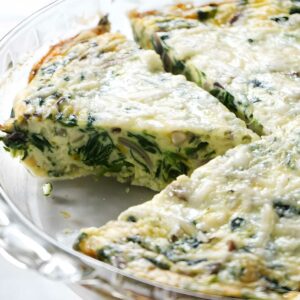 Crustless quiche in a glass dish, one slice removed.