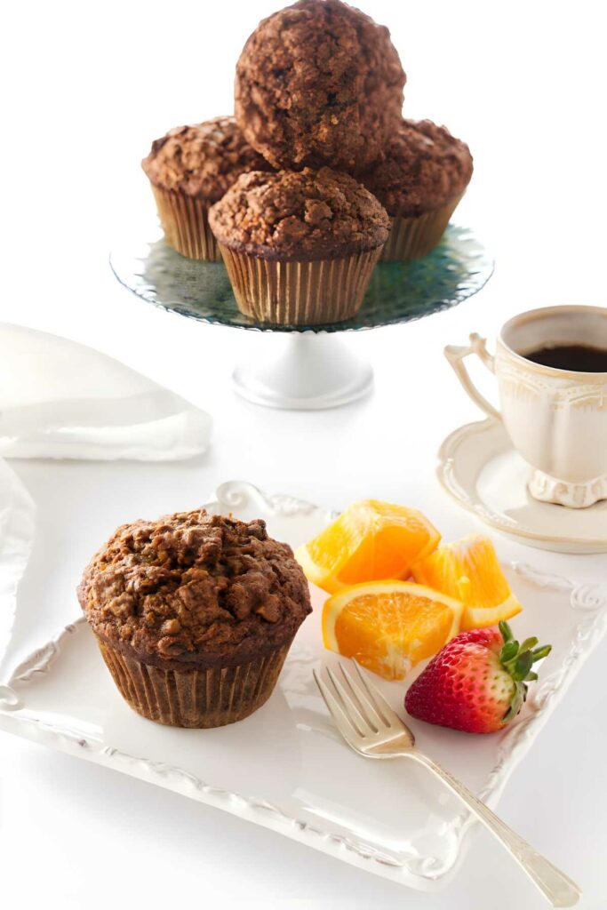 Carrot apple muffin with orange slices, strawberry, and coffee.