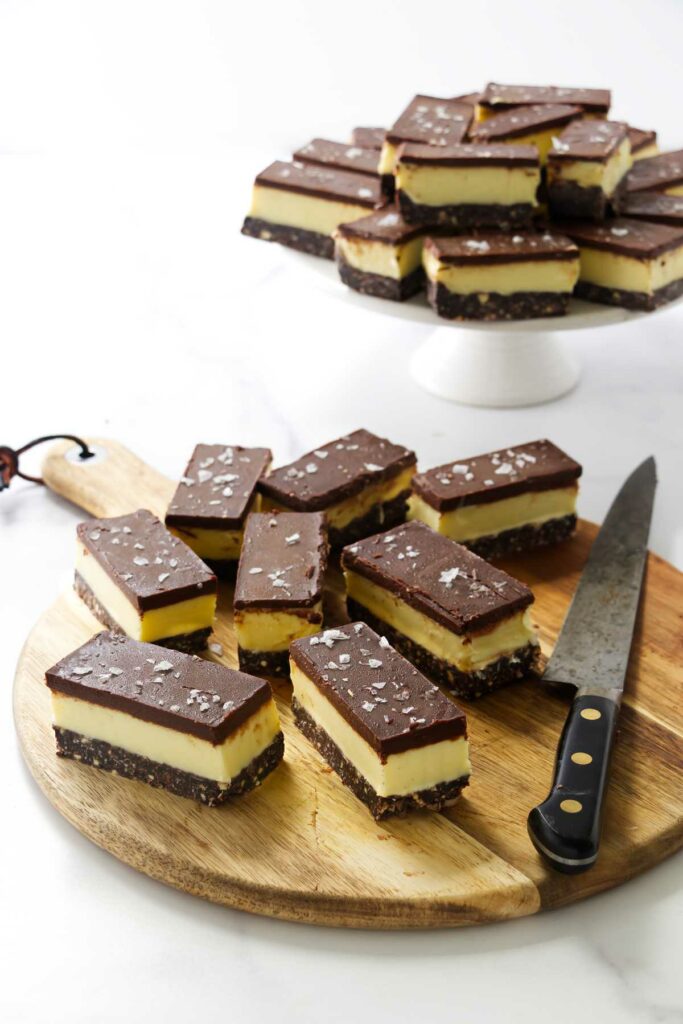 Several sliced nanaimo bars on a cutting board.