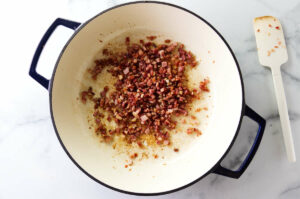 Crispy pancetta in a skillet.
