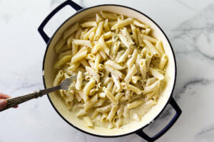 Stirring pasta into pistachio sauce.