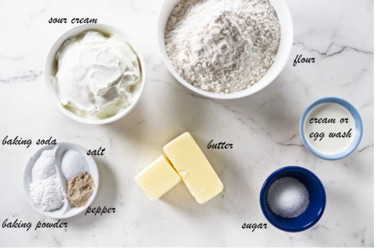 Overhead view of assorted baking ingredients arranged on a white surface.