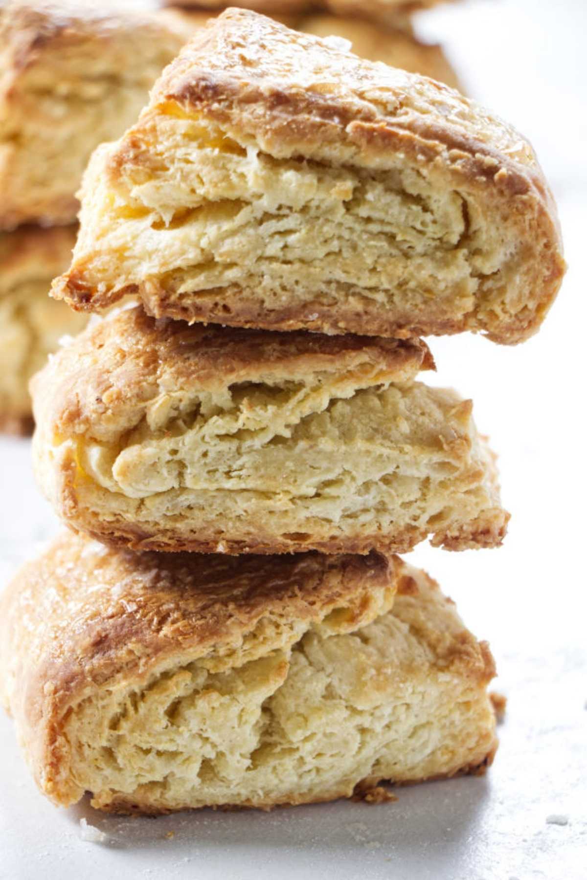 Stack of three sour cream biscuits on a counter.