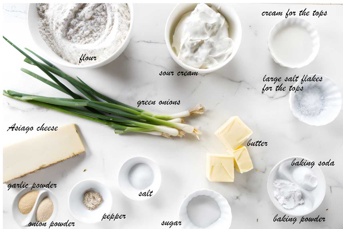 Recipe ingredients, including green onions and cheese, arranged on a white surface.