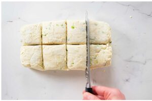Hand cuts cheese and sour cream biscuits.