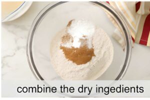Glass bowl with spelt flour, baking powder, cinnamon; striped cloth nearby. Text: combine.